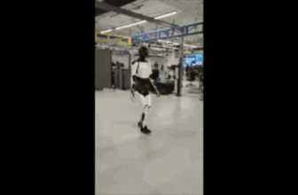 elon musk optimus tesla robotic blurry cellphone 2002